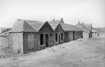 View from SE showing ENE and SSE fronts of store block with office block in background