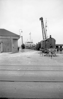 View looking N from WSW bridge entrance showing crane no 7 with coaster MV Fylhix in background