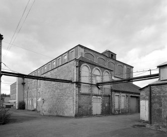 Digital image of a view from E of NE end of former Mule Spinning Mill, with buildings B4 & B5 in foreground, and main mill in background (B6)