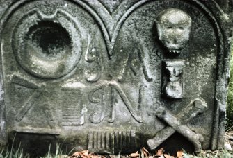 View of headstone to barber d. 1729, showing bowl, razors and combs, Alloa Old Parish Church.