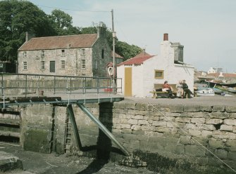 View from SW showing harbour footbridge with Harbourmaster's House in the background.