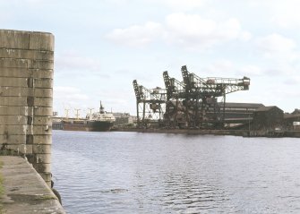 General view from NW showing cranes with transporter ship in background