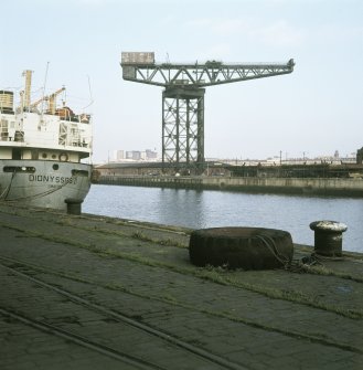 View from SSE showing crane with part of 'Dionyssos II' in foreground