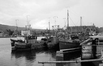 View from NE showing fishing boats moored on old quay