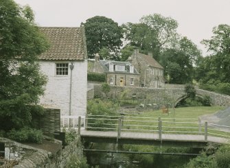 General view from NNW showing bridge, cottage and Masons Lodge in background