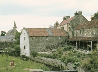 View from S showing WSW and SSE fronts at rear of museum with church in background