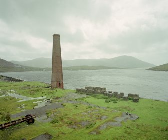 View from NNE of surviving boiler-house chimney.  To left of chimney was milling area, the boiler house being situated in the foreground.  The concrete structures to the right were bases for whale oil tanks
Digital image of C 68895 CN