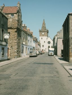 General view from SW showing High Street with SE and part of SW fronts of Lodge (second from left) and church in background