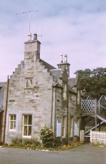 View from ESE showing NE and part of SE fronts of down platform building with footbridge in background