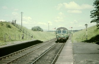 View from WSW showing train from Lanark approaching station