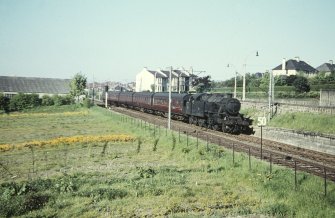 View from E showing 42170 Whitecraigs - Glasgow train approaching station