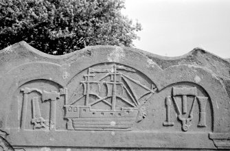 View of gravestone of James Lamb, 1776. Carving of a brig ship and shipwright's tools.