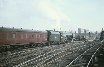 View from NW showing locomotive 46223 and carriages departing station