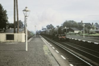 View from NNW showing locomotive no 60325 on Glasgow - Aberdeen train approaching station