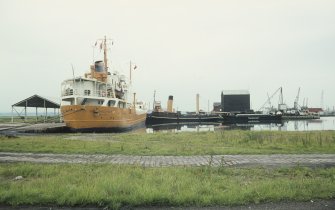General view from SW showing tanker and ships moored in dock