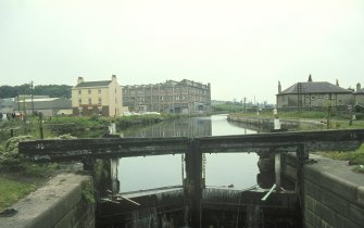 View from ENE showing S lock gate with inn in left background and terraced houses in right background