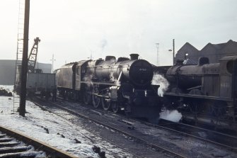 View from NE showing locomotives with part of engine shed in background