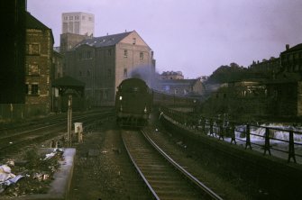 View from WNW showing Dalmuir train approaching station with parts of Scotstoun mills to left and Regent mills in background