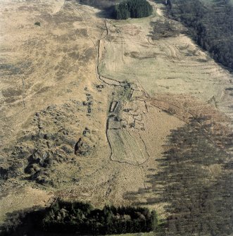 Oblique aerial view of Glen Muick centred on the remains of a township, rig and head-dyke, taken from the NNW.