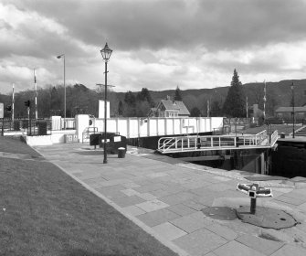 Fort Augustus, Swing Bridge over Caledonian Canal
An oblique view of the swing bridge, looking east, with a pair of lock gates in the middle distance.  In the foreground stands a capstan
Digital image of D 64043
