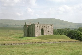 View of Hermitage Castle from north-west, showing the earthwork in the foreground which survives from the 13th century predecessor to the 14th to 16th century stone castle.
Digital image of C 67763 CN
