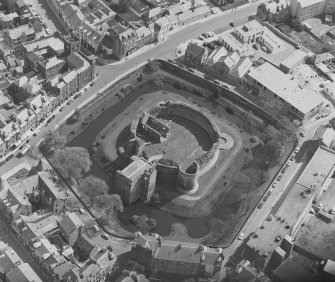 Oblique aerial view centred on the remains of Rothesay Castle, Bute.