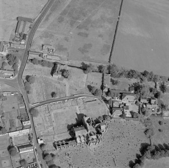 Oblique aerial view, taken from the SW, centred on the remains of the Abbey. The cropmarks of buildings are visible in the top centre half of the photograph.
Digital image of C 53401