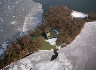 Oblique aerial view of Lochleven Castle in the snow.
