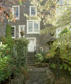 View of rear of house from South West showing 18th century pineapple finialed gatepiers and garden door
Digital image of E 30902 CN