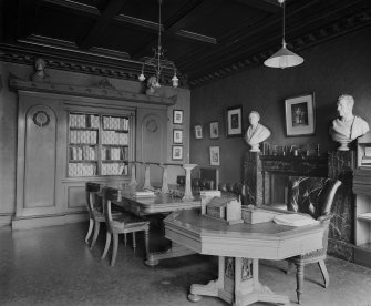 Interior-general view of one of the rooms with busts on either side of marble fireplace and two large tables in centre of room