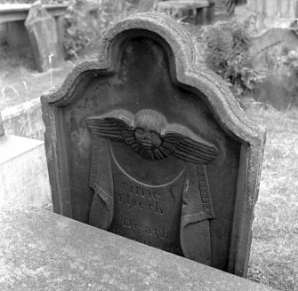 View of standing tombstone, St Mary's Church burial ground, Banff, with winged soul at top above holding drape and inscribed 'time Flyeth, Death Persueth'.