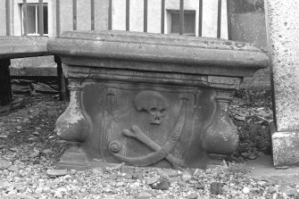 View of table tomb with skull, bone, Sexton's tools and scroll inscribed 'Memento Mori', St Mary's Church burial ground, Banff.