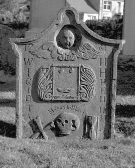 General view of West face of the tombstone commemorating Alexander Henderson's parents. A winged soul above weaving loom and shuttle with foliate surround, crossed bones, skull and hourglass. Insc: '1761. WH, IH, GH, IH, DH, IH, AH. Memento Mori'.
St. Serf's Parish Church & Graveyard, Dunning. Digital image of PT 4314
