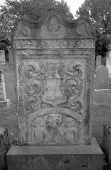 Logierait Parish Church.
Gravestone commemorating the three wives of Peter McFarland, 1781. Winged soul over armorial panel with sock and coulter of the plough, with Adam and Eve scene.
Digital image of PT 15107