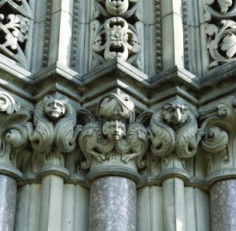 Detail showing gargoyles on colonette capitals to right hand side of main entrance in SW elevation.