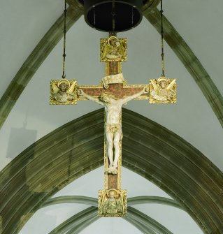 Interior.
View of crucifix suspended from archway between nave and crossing area.