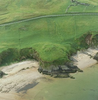 Oblique aerial view of the remains of the broch, taken from the SE.