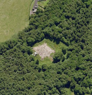 Oblique aerial view centred on the excavation of the old castle, taken from the NW.