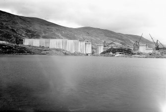 General view from W of Dam under construction. Photograph taken looking E from Tunnel Tip.
Copy of negative, Mullardoch-Fasnakyle-Affric, Box 873/1, Contract No. 9, Plate No. 141.