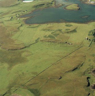 Canna and Sanday. Aerial view of Roman Catholic Church of St Edward the Confessor and Canna Harbour, pier with nearby sites, buildings and monuments at Eilean a' Bhaird, Greod, Cnoc an Tionail, Am Mialagan and Creag Liath.

