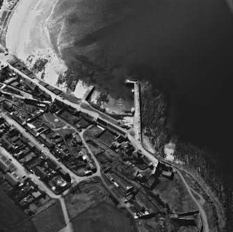 Aerial view of village, showing harbour.
