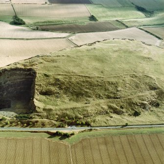 Oblique aerial view centred on the remains of the fort showing recent fire damage, taken from the N.