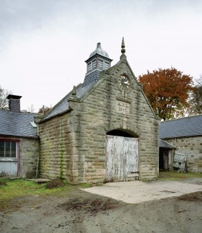 Detailed view from SW of ornate projecting bay in middle of S side of steading, containing clock and ornate ventilator, Glenkindie Home Farm.