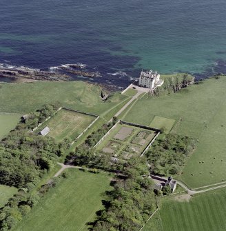 Oblique aerial view of Dunbeath Castle and walled gardens from SW.