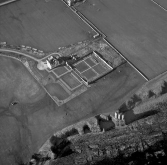 Oblique aerial photograph showing old and new castles, and nissen huts
