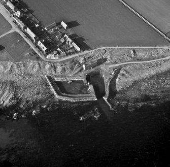 Oblique aerial view of harbour and part of village.