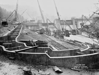 View from NE showing fishladder, in foreground, and dam, in background, under construction.
Copy of 'Clunie Dam. General view of Fishladder. Ser. No. 86. Date: 9/11/49'.