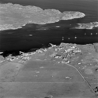 Oblique aerial view of Arinagour, taken from the north west, centred on the town.