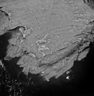 Stroma, oblique aerial view, taken from the N, centred on the lighthouse, and showing the edge of Nethertown township in the top half of the photograph.