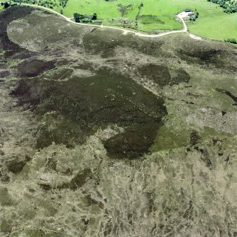 Cnoc Cairaidh, Achnagarron, oblique aerial view, taken from the NE, centred on an area with hut-circles, a field-system and possible cord rig. Standing stones and a building are visible in the top right-hand corner of the photograph.